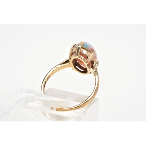 15 - A 9CT GOLD DRESS RING, designed with an oval foil glass cabochon imitating an opal in a six claw set... 