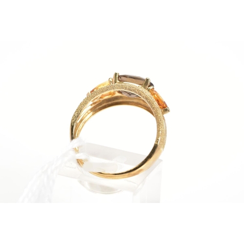 16 - A 9CT GOLD SMOKY QUARTZ AND CITRINE DRESS RING, the textured split band set with a central oval cut ... 