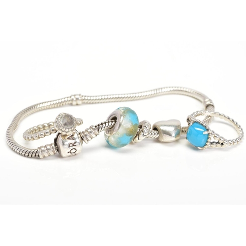 21 - A PANDORA BRACELET AND TWO PANDORA RINGS, the charm bracelet suspending three charms, both rings of ... 