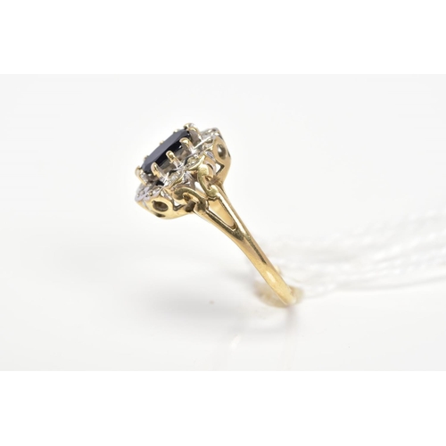 22 - A 9CT GOLD SAPPHIRE AND DIAMOND CLUSTER RING, designed as a central oval sapphire within a single cu... 