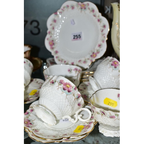 255 - AN EARLY AYNSLEY TEASET, Rd No 334379, floral pattern edging on white ground, comprising six side pl... 