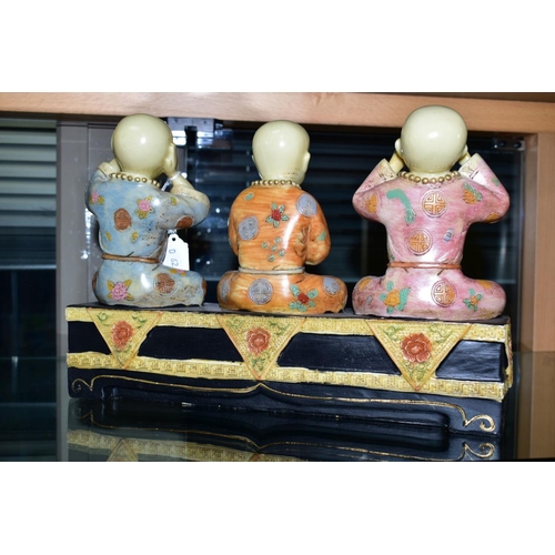 257 - A MODERN FIGURE GROUP OF BUDDHAS, in the See No Evil, Hear No Evil and Speak No Evil positions, heig... 