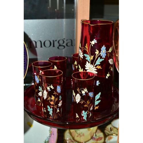 258 - A FLORALLY ENAMELLED CRANBERRY GLASS LEMONADE SET, comprising a jug, height 25cm and five matching g... 