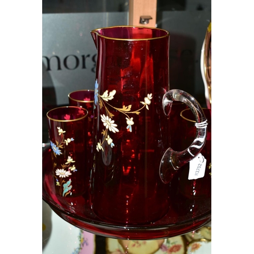 258 - A FLORALLY ENAMELLED CRANBERRY GLASS LEMONADE SET, comprising a jug, height 25cm and five matching g... 