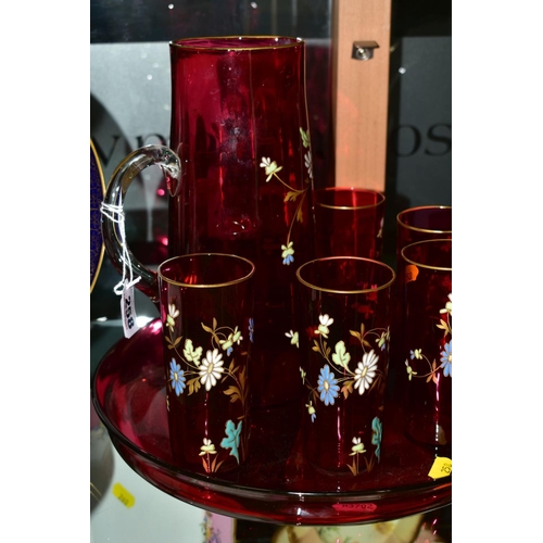 258 - A FLORALLY ENAMELLED CRANBERRY GLASS LEMONADE SET, comprising a jug, height 25cm and five matching g... 