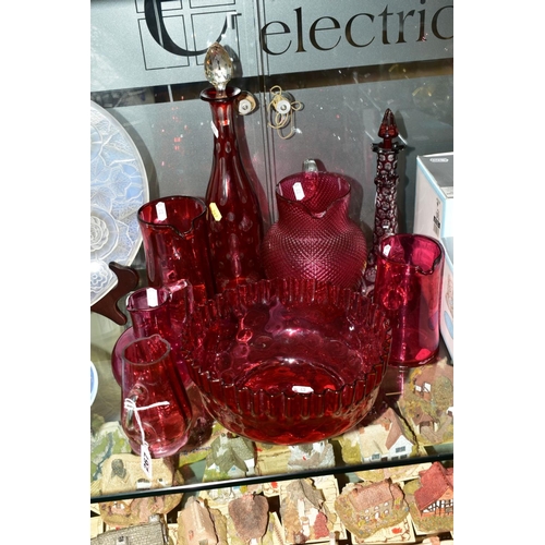 267 - A GROUP OF CRANBERRY COLOURED GLASS ITEMS, to include five various jugs, tallest 18cm, smallest 12.5... 