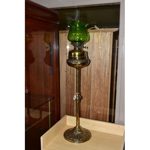 282 - A LATE 19TH/EARLY 20TH CENTURY BRASS OIL LAMP, having brass reservoir, glass funnel and green glass ... 