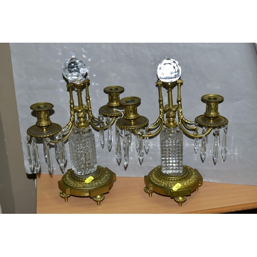 308 - A PAIR OF GILT METAL AND CRYSTAL CANDELABRA, each consisting of two arms attached to a central colum... 