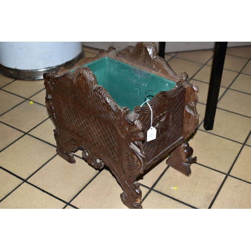 311 - A 19TH CENTURY BLACK FOREST WOODEN PLANTER, with porcelain panel depicting a male figure playing the... 