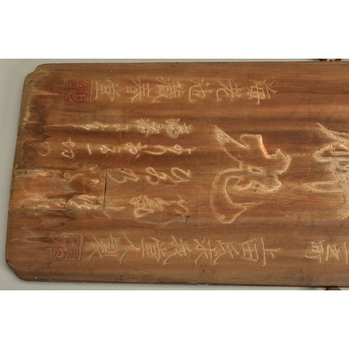 1381 - A 19TH CENTURY CHINESE HARDWOOD BOARD CARVED WITH SCRIPT AND SEALS, traces of gilding, fitted with a... 