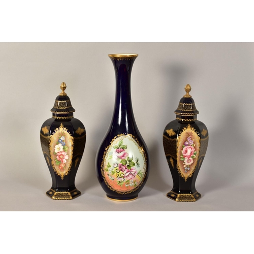 335 - A PAIR OF LIMOGES VASES AND COVERS, with hand painted floral panels and gilt detailing on a dark blu... 