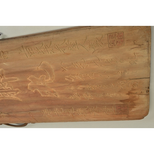 1381 - A 19TH CENTURY CHINESE HARDWOOD BOARD CARVED WITH SCRIPT AND SEALS, traces of gilding, fitted with a... 