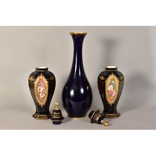 335 - A PAIR OF LIMOGES VASES AND COVERS, with hand painted floral panels and gilt detailing on a dark blu... 