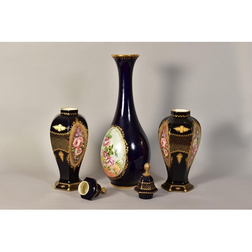 335 - A PAIR OF LIMOGES VASES AND COVERS, with hand painted floral panels and gilt detailing on a dark blu... 