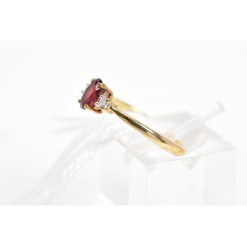 34 - A 9CT GOLD GARNET AND PASTE RING, designed as a central oval shape garnet flanked by a circular colo... 