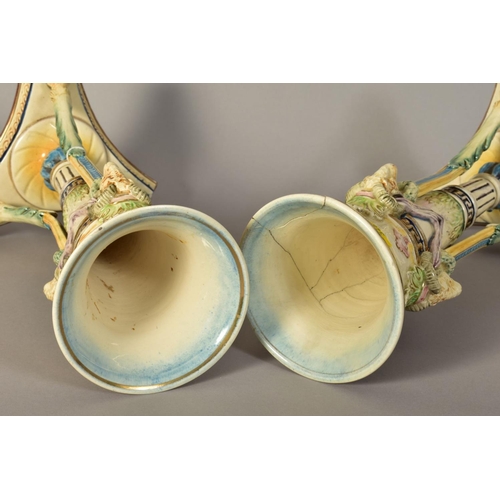 348 - A PAIR OF CONTINENTAL MAJOLICA HUGO LONITZ VASES, of trumpet form having Rams head masks supported o... 