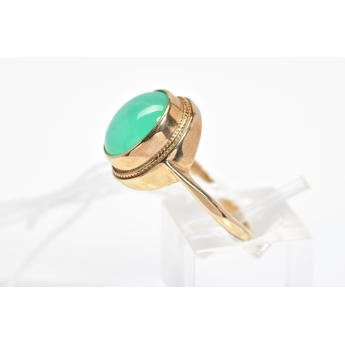 35 - A 9CT GOLD GEM RING, designed as a collet set green gem cabochon assessed as chrysoprase, within a f... 