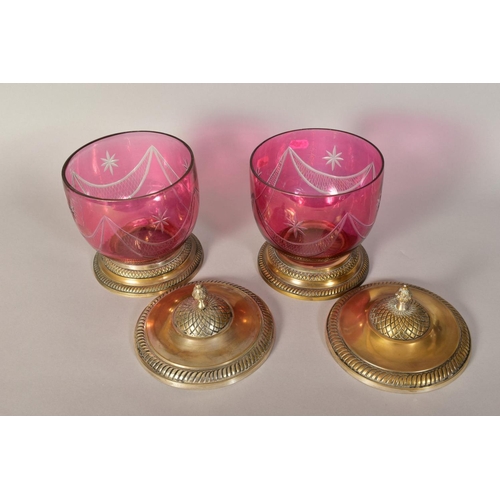 380 - A PAIR OF CRANBERRY COLOURED BISCUIT BARRELS (?), with plated covered and plated bases, heights appr... 