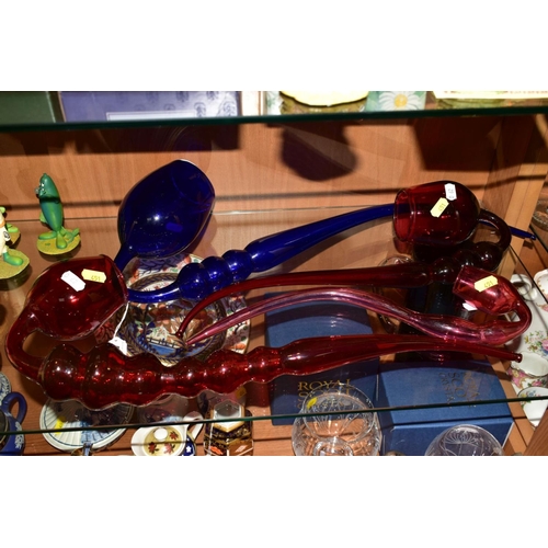 451 - A LARGE BRISTOL BLUE GLASS PIPE, length 57cm (cracks along rim) together with three similar cranberr... 