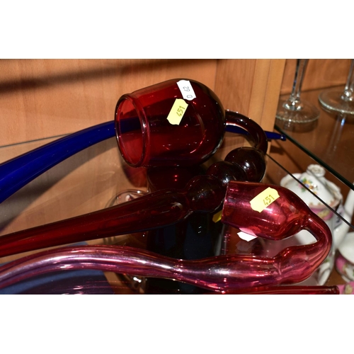 451 - A LARGE BRISTOL BLUE GLASS PIPE, length 57cm (cracks along rim) together with three similar cranberr... 