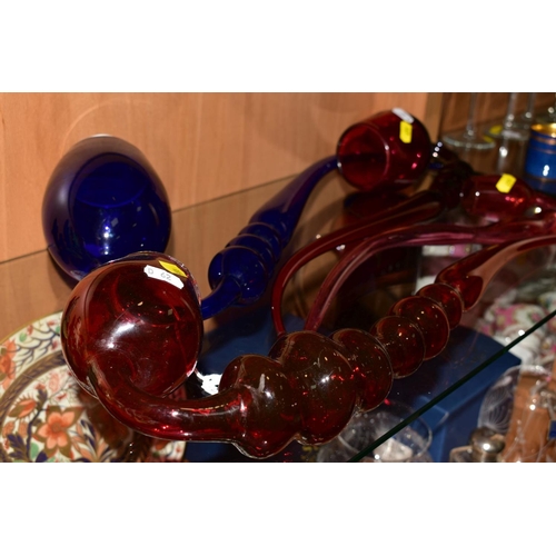 451 - A LARGE BRISTOL BLUE GLASS PIPE, length 57cm (cracks along rim) together with three similar cranberr... 