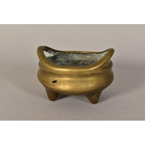 466 - A CHINESE POLISHED BRONZE TRIPOD CENSER, 18th / 19th Century, looped handles, cast mark to underside... 