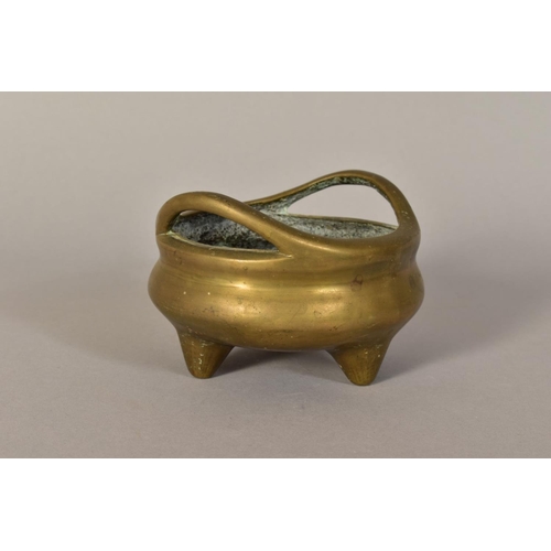 466 - A CHINESE POLISHED BRONZE TRIPOD CENSER, 18th / 19th Century, looped handles, cast mark to underside... 