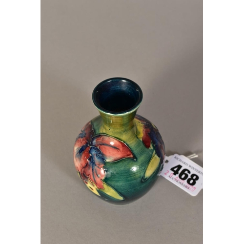 468 - A SMALL MOORCROFT POTTERY BUD VASE, 'Orchid' pattern on green ground, Queen Mary paper label to base... 