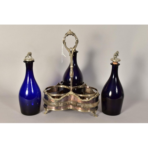 486 - A VICTORIAN PLATED TREFOIL DECANTER STAND, containing three blue glass decanters with novelty stoppe... 