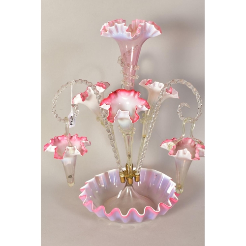 487 - A VICTORIAN VASELINE GLASS EPERGNE, with central frilled pink trumpet vase, framed by three further ... 