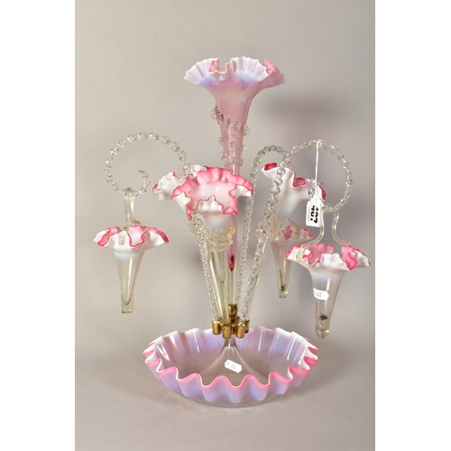 487 - A VICTORIAN VASELINE GLASS EPERGNE, with central frilled pink trumpet vase, framed by three further ... 