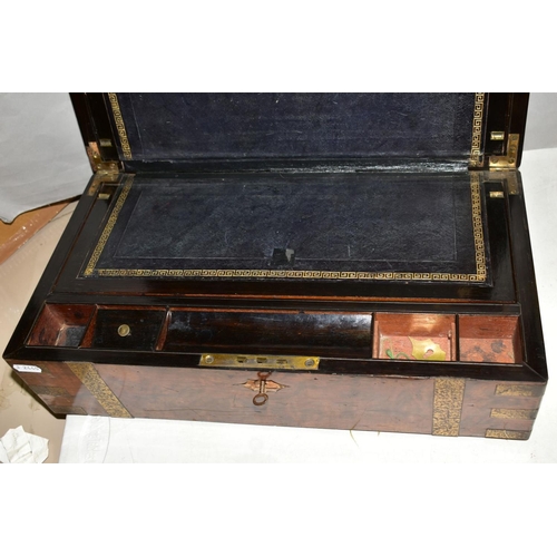 551 - A WOODEN BRASS BOUND WRITING SLOPE, distressed leather, brass escutcheons and cartouche are loose, l... 