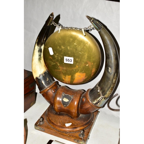 553 - AN OAK BASED DINNER GONG with cow horn supports and silver plated mounts, approximate height 43cm (m... 