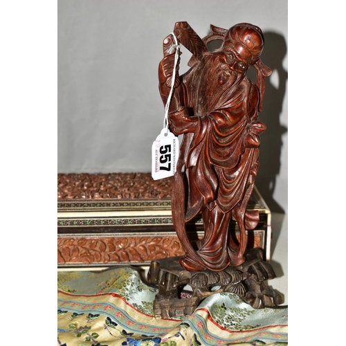 557 - A CARVED WOODEN JAPANESE FIGURE STANDING ON AN OLDER CARVED BASE, approximate height 22cm, together ... 