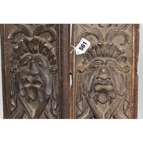 561 - TWO CARVED TREEN PANELS, of rectangular form, 17th Century and later, carved with identical mask and... 