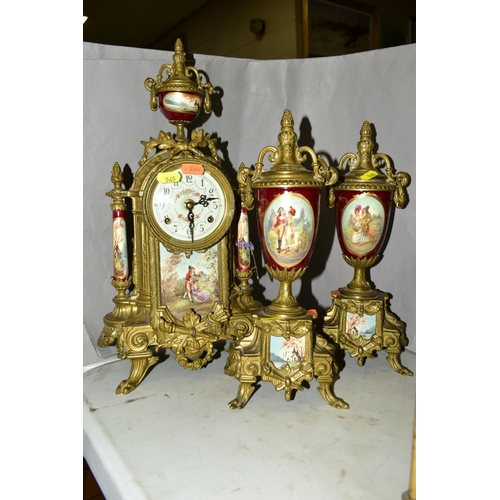 565 - A FRANZ HERMLE & SONS OF GERMANY BRASS CLOCK GARNITURE IN THE LOUIS XIV STYLE, painted porcelain pan... 