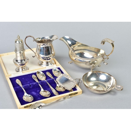 79 - A GROUP OF 20TH CENTURY SILVER, comprising an oval sauceboat, gadrooned rim, S scroll handle, on thr... 