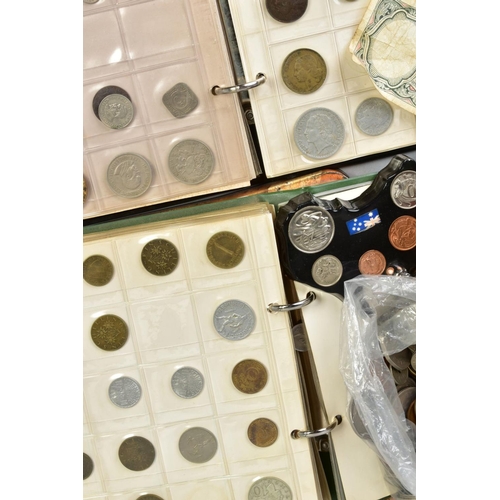 100 - A BISCUIT TIN OF COINS to include two small albums of world coins, some with silver content etc