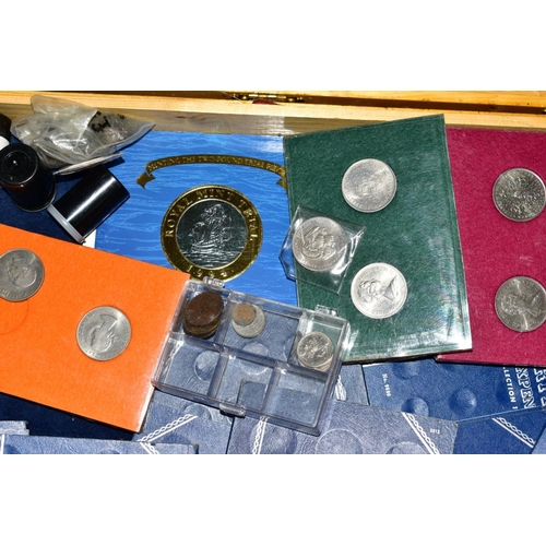 128 - A LARGE COLLECTION OF COINS AND COMMEMORATIVES to include four purpose made coin cases, 24'' x 18'' ... 