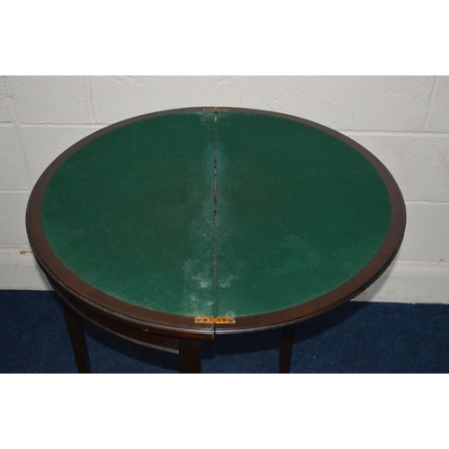 1287 - AN EDWARDIAN MAHOGANY DEMI LUNE FOLD OVER CARD TABLE on four legs and spade feet, width 76cm x close... 