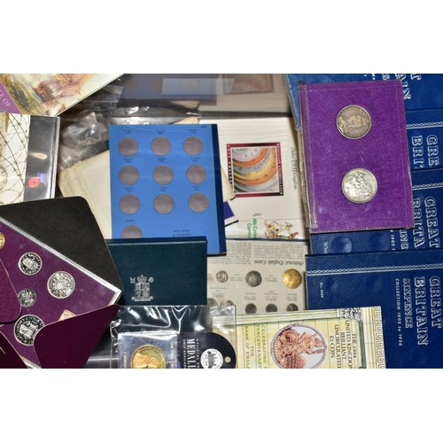 129 - A LARGE BOX AND TUB OF COINS AND COMMEMORATIVES to include fourteen proof United Kingdom year sets w... 