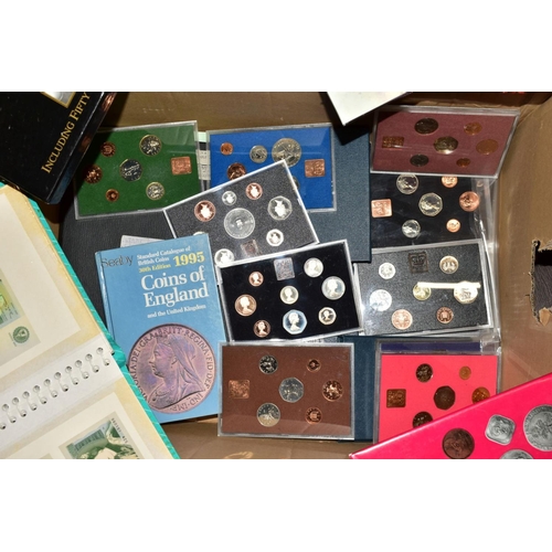 129 - A LARGE BOX AND TUB OF COINS AND COMMEMORATIVES to include fourteen proof United Kingdom year sets w... 