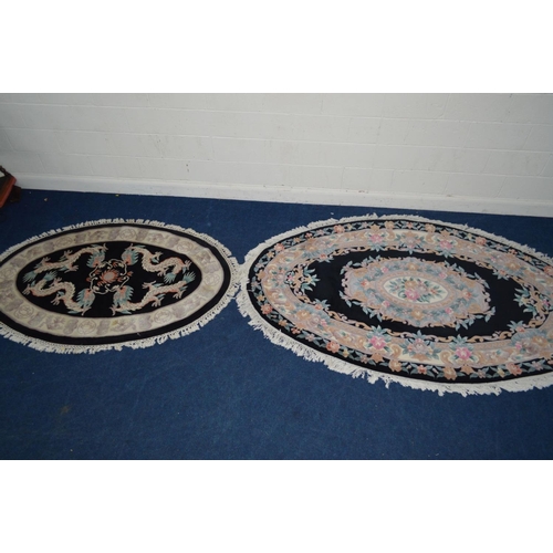 1291 - A LARGE G H FIRTH OVAL WOOLLEN CHINESE BLACK GROUND RUG, 250cm x 160cm and a similar smaller rug (2)