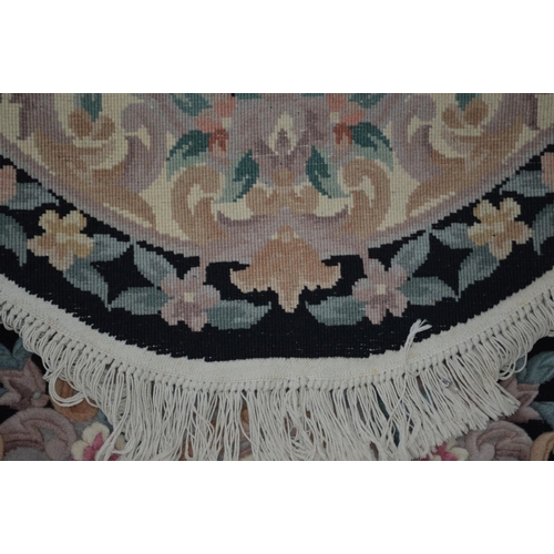 1291 - A LARGE G H FIRTH OVAL WOOLLEN CHINESE BLACK GROUND RUG, 250cm x 160cm and a similar smaller rug (2)