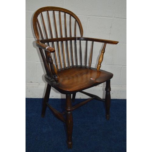 1292 - AN EARLY 19TH CENTURY ELM HOOP BACK WINDSOR ARMCHAIR, spindle back and arms on turned legs united by... 