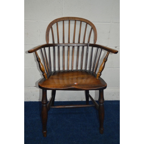 1292 - AN EARLY 19TH CENTURY ELM HOOP BACK WINDSOR ARMCHAIR, spindle back and arms on turned legs united by... 