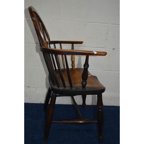 1292 - AN EARLY 19TH CENTURY ELM HOOP BACK WINDSOR ARMCHAIR, spindle back and arms on turned legs united by... 