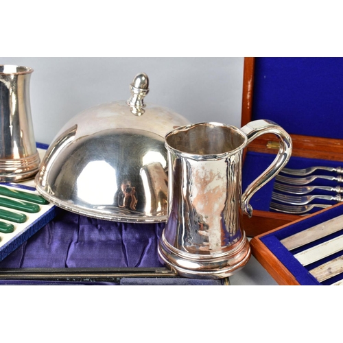 141 - A SMALL QUANTITY OF SILVER PLATE, including two Sheffield plated tankards, a circular dome, cased ho... 