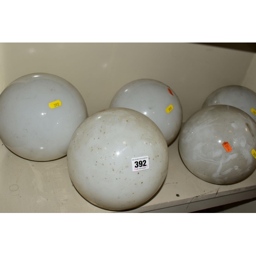 392 - A SET OF FIVE OPAQUE WHITE GLASS SPHERICAL CEILING LIGHT SHADES WITH FOUR OVER PAINTED METAL FITTING... 