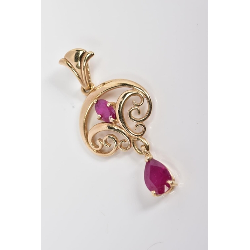 50 - A 9CT GOLD RUBY PENDANT, of open work scrolling design set with a central oval cut ruby suspending a... 